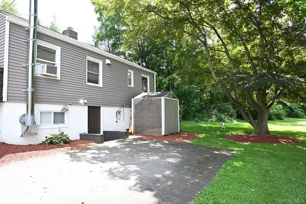 a front view of a house with a garden and yard