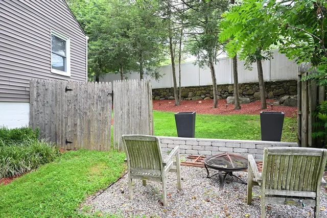a view of a patio with a table and chairs