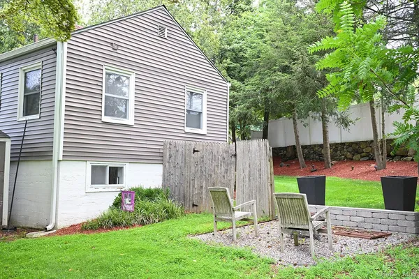 a view of backyard with a garden and outdoor seating