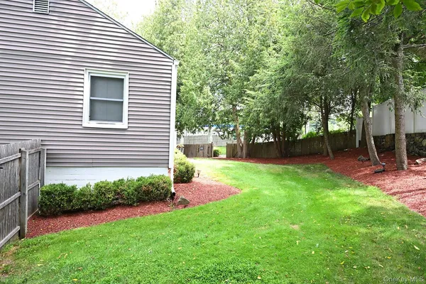a view of backyard with a garden and entertaining space