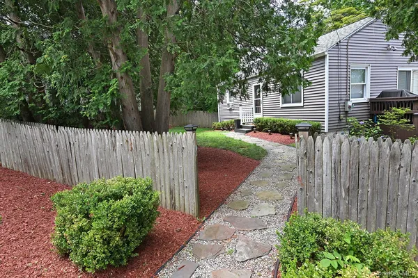 a view of a pathway with a garden