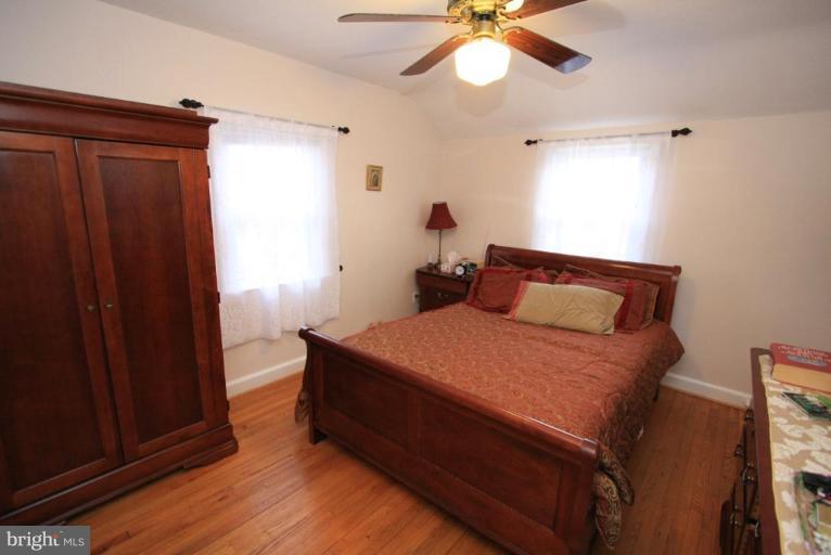 9924 Grayson Avenue Silver Spring, MD 20901 - Photo 2 of 26 a bedroom with a bed and a chandelier