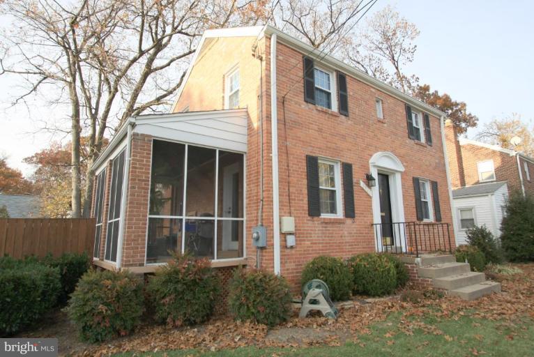 9924 Grayson Avenue Silver Spring, MD 20901 - Photo 11 of 26 a view of a brick house with large windows and plants