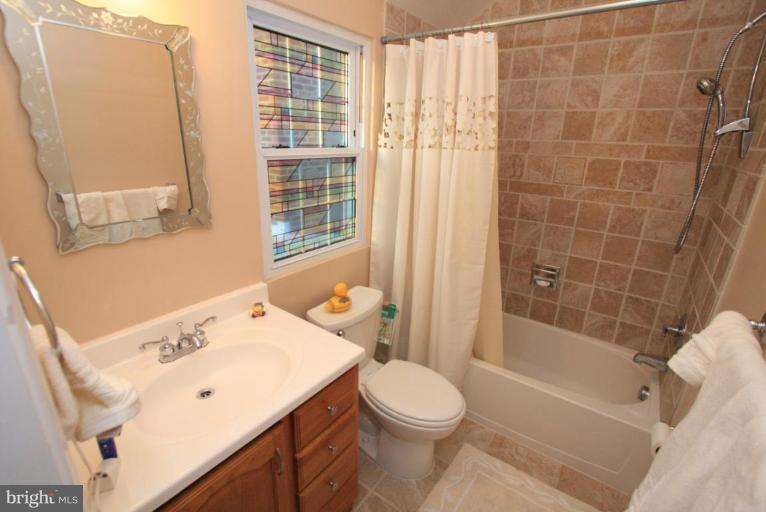 9924 Grayson Avenue Silver Spring, MD 20901 - Photo 14 of 26 a bathroom with a sink a toilet and shower