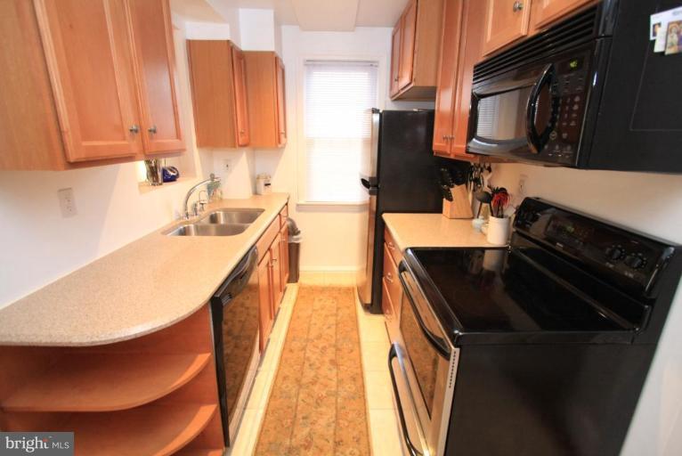 9924 Grayson Avenue Silver Spring, MD 20901 - Photo 15 of 26 a kitchen that has a sink and a stove