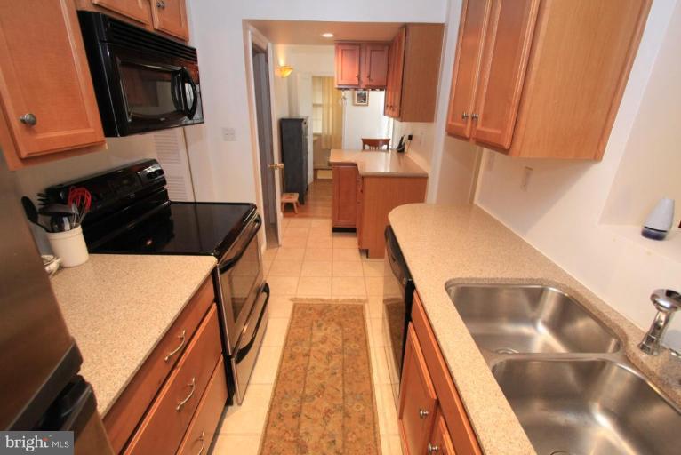 9924 Grayson Avenue Silver Spring, MD 20901 - Photo 16 of 26 a kitchen with stainless steel appliances a refrigerator and a stove top oven
