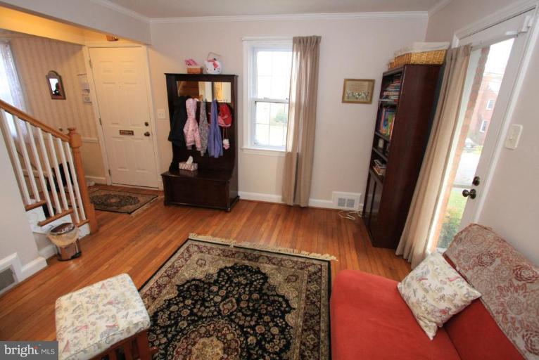 9924 Grayson Avenue Silver Spring, MD 20901 - Photo 19 of 26 a view of a hallway with wooden floor and furniture