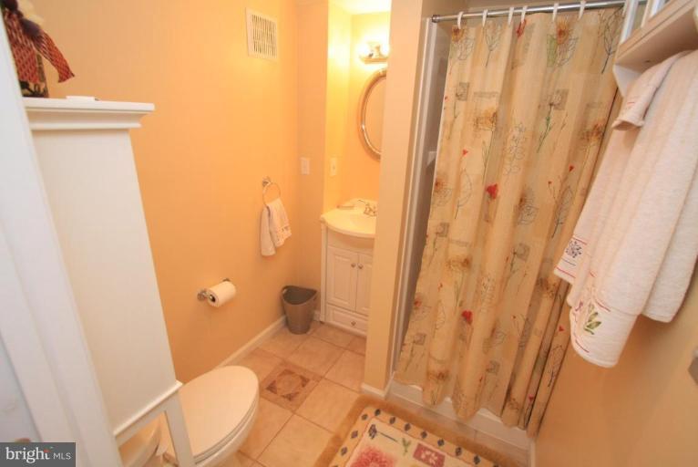 9924 Grayson Avenue Silver Spring, MD 20901 - Photo 20 of 26 a bathroom with a granite countertop shower and a toilet