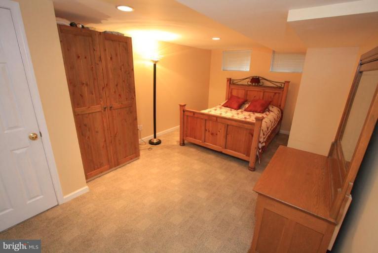 9924 Grayson Avenue Silver Spring, MD 20901 - Photo 21 of 26 a bed room with a bed and a mirror
