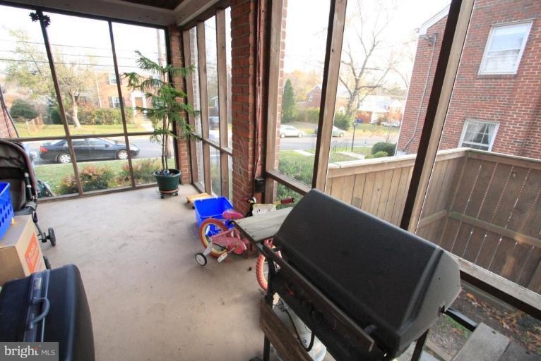 9924 Grayson Avenue Silver Spring, MD 20901 - Photo 23 of 26 a living room with furniture and a floor to ceiling window