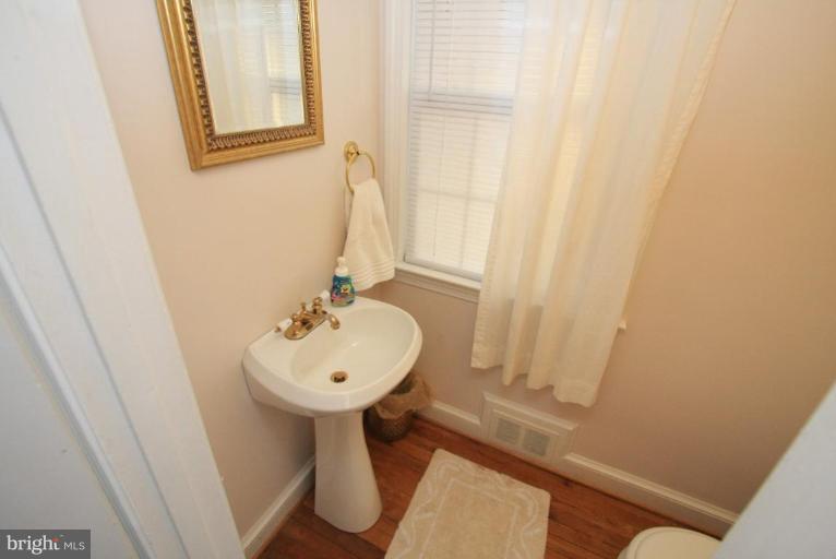 9924 Grayson Avenue Silver Spring, MD 20901 - Photo 24 of 26 a bathroom with a sink and a mirror