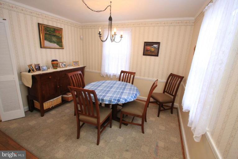 9924 Grayson Avenue Silver Spring, MD 20901 - Photo 6 of 26 a view of a dining room with furniture and a chandelier