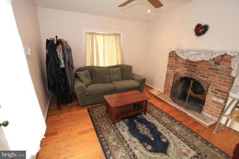 9924 Grayson Avenue Silver Spring, MD 20901 - Photo 8 of 26 a living room with furniture and a fireplace