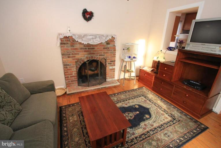 9924 Grayson Avenue Silver Spring, MD 20901 - Photo 9 of 26 a living room with furniture and a fireplace