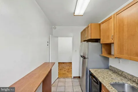 a kitchen with granite countertop a stove a sink and a microwave