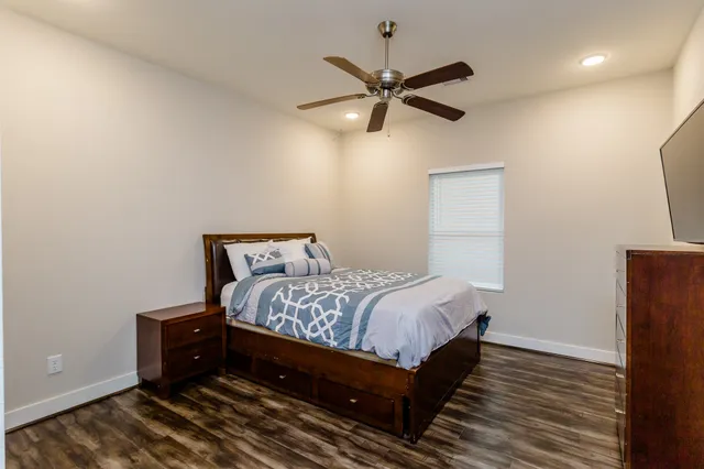 a bedroom with a bed and a window