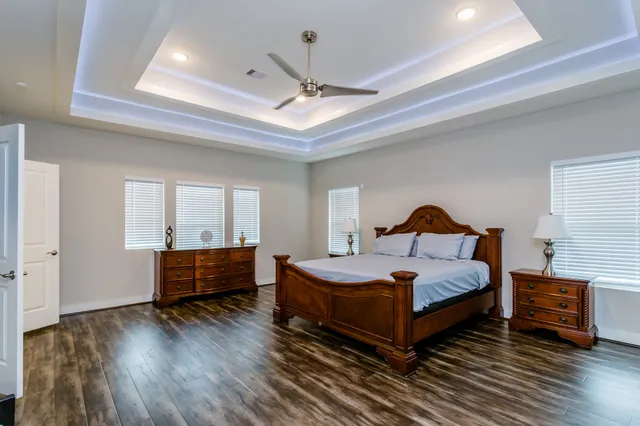 a bedroom with a bed and wooden floor
