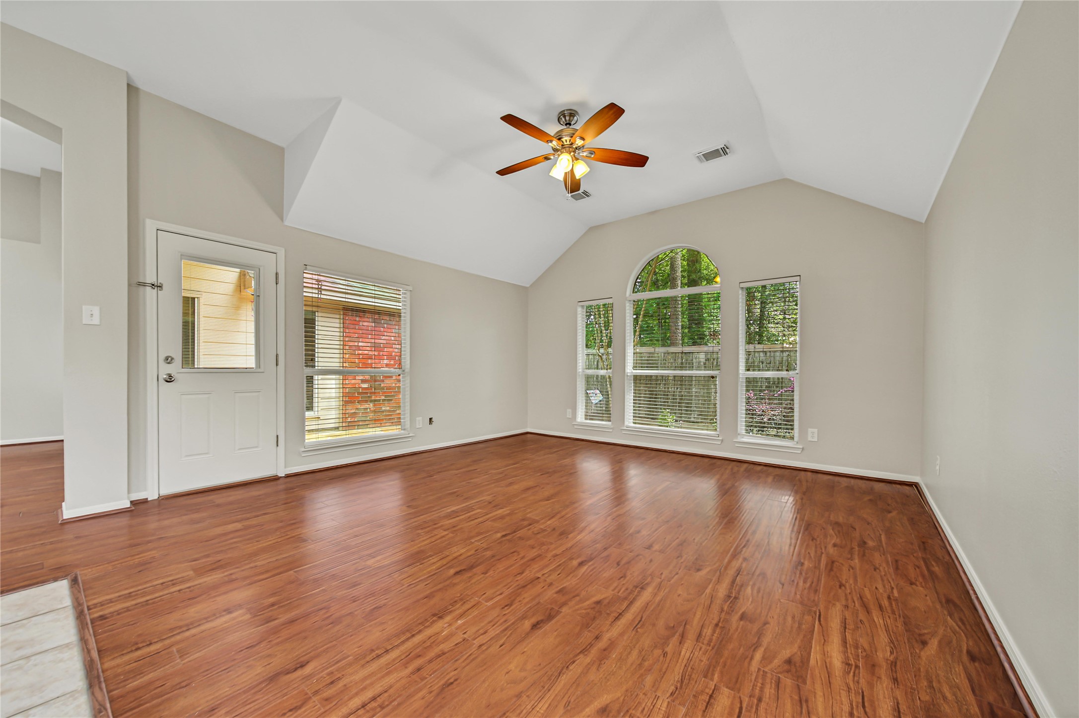 14526 Red Tailed Hawk Lane Houston, TX 77044 - Photo 19 of 40 a view of an empty room with wooden floor and a window
