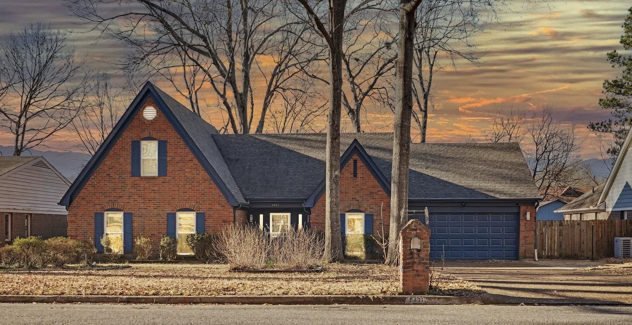 English style home featuring brick siding, a shingled roof, an attached garage, and driveway