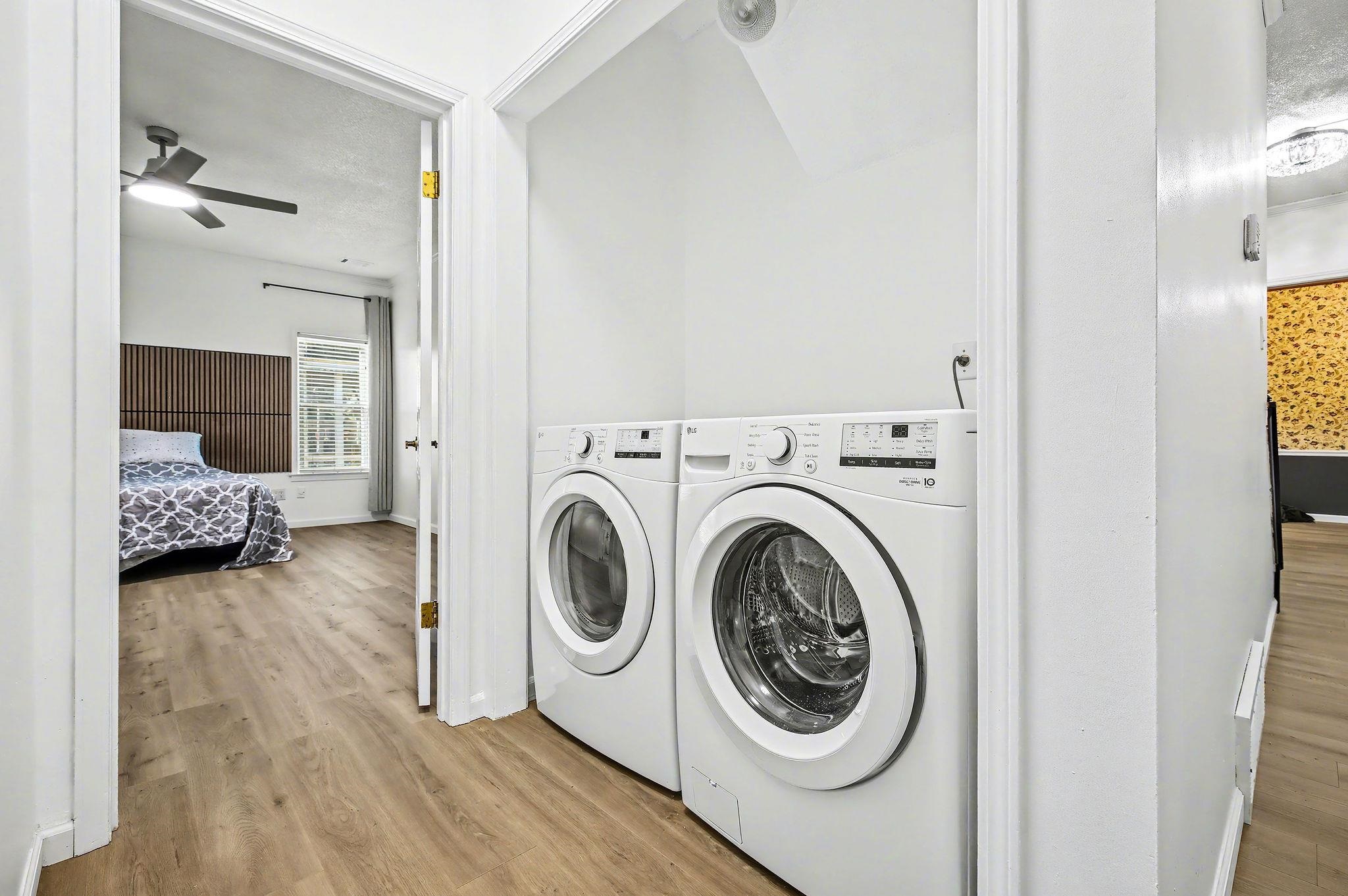 8431 Bazemore Road Cordova, TN 38018 - Photo 11 of 23 Laundry area featuring washer and dryer, and light wood-style floors.