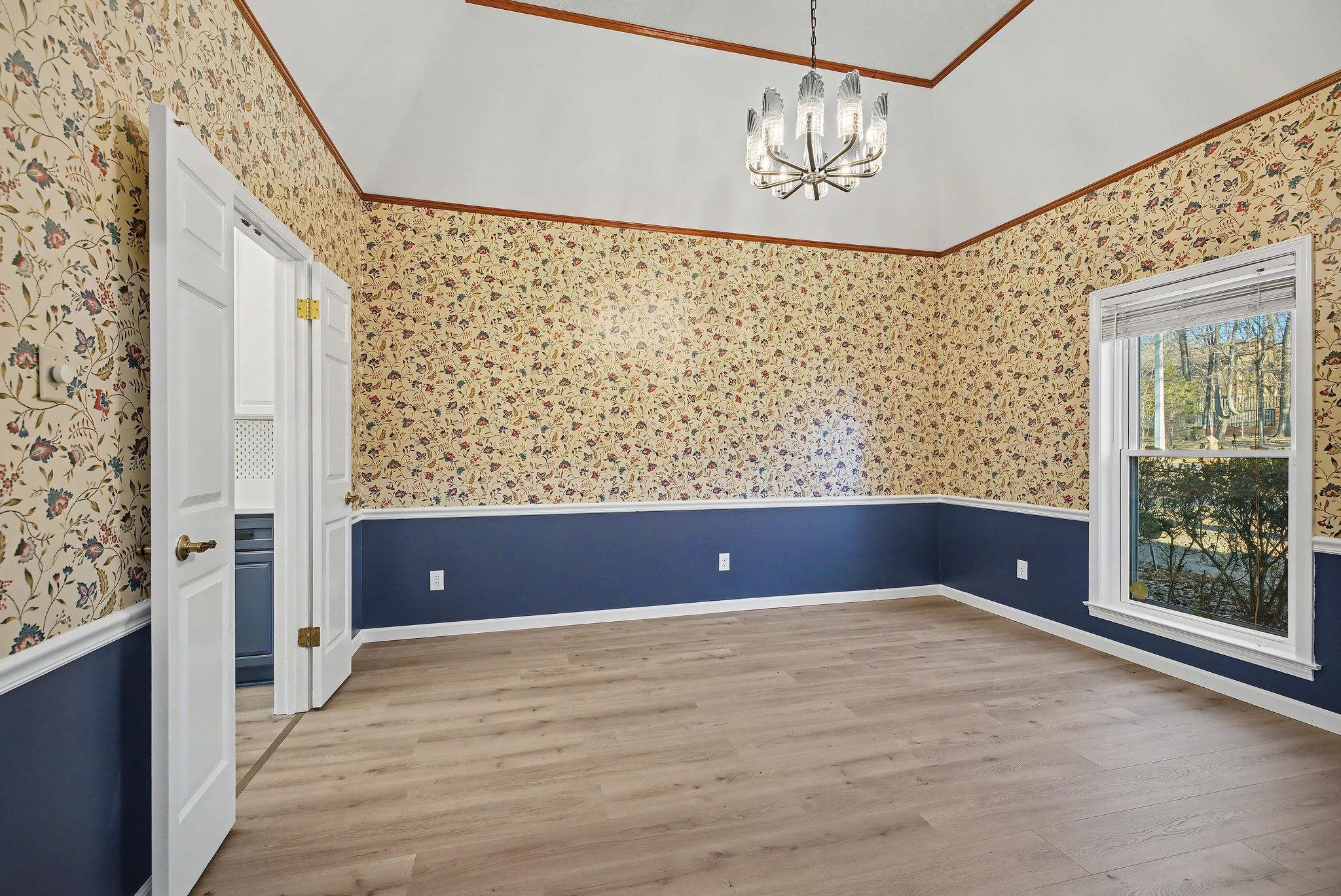 8431 Bazemore Road Cordova, TN 38018 - Photo 2 of 23 Dining room with a chandelier, wainscoting, wallpapered walls, and light wood-style flooring