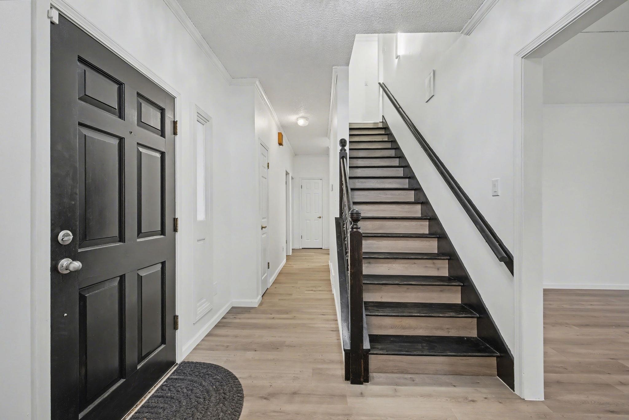 8431 Bazemore Road Cordova, TN 38018 - Photo 7 of 23 Entryway featuring light wood-style flooring, a textured ceiling, and crown molding