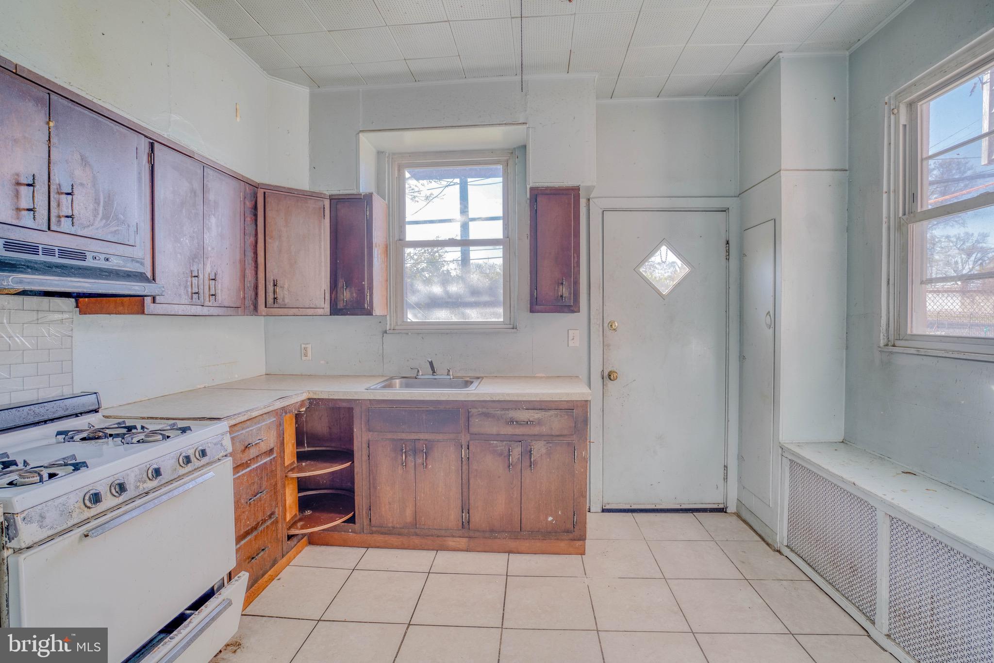 5705 Leonard Street Philadelphia, PA 19149 - Photo 13 of 30 a kitchen with a stove a sink and a refrigerator
