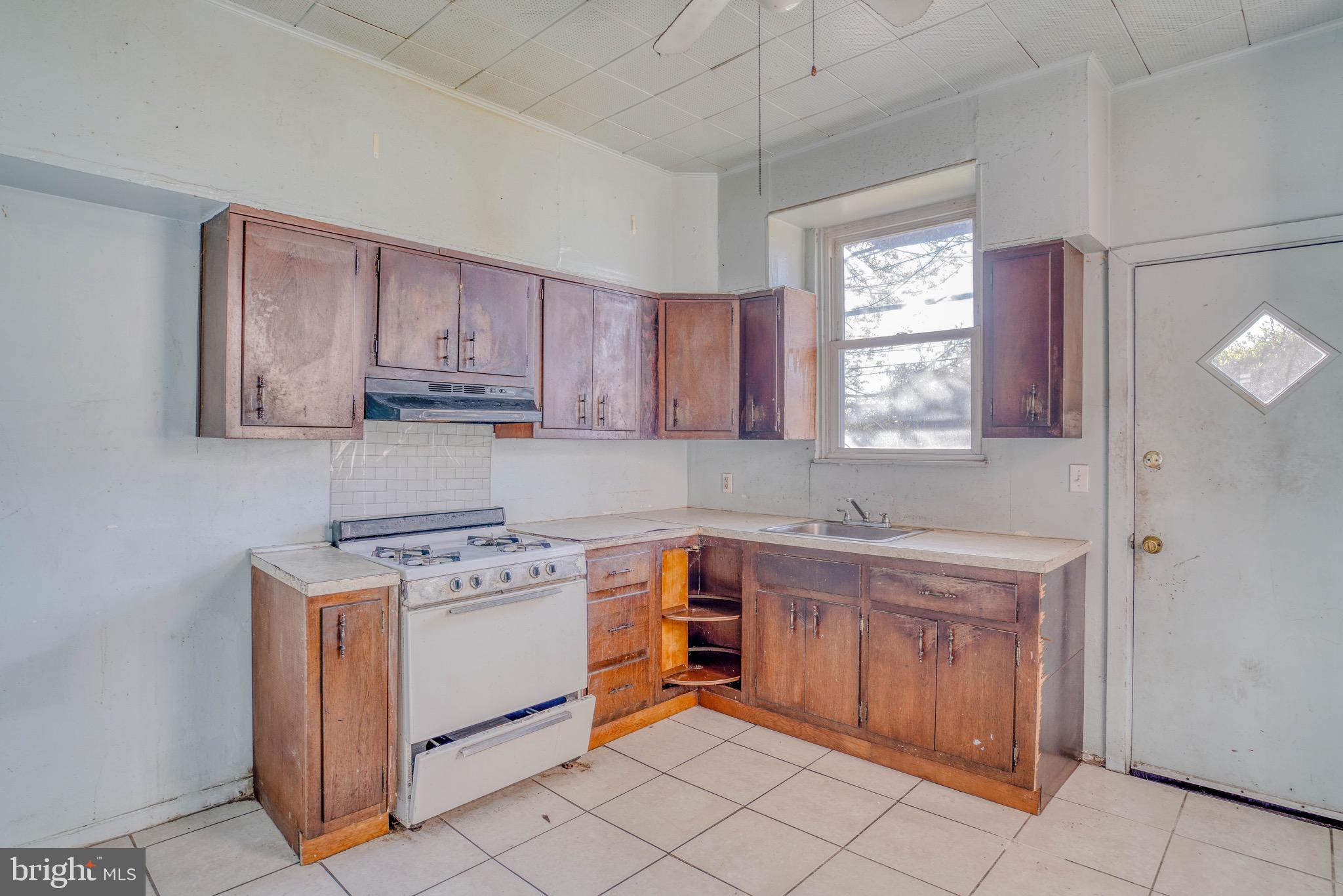 5705 Leonard Street Philadelphia, PA 19149 - Photo 14 of 30 a kitchen with a stove a sink and a window