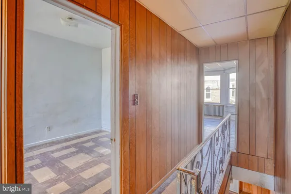 a view of a hallway with wooden floor and entryway