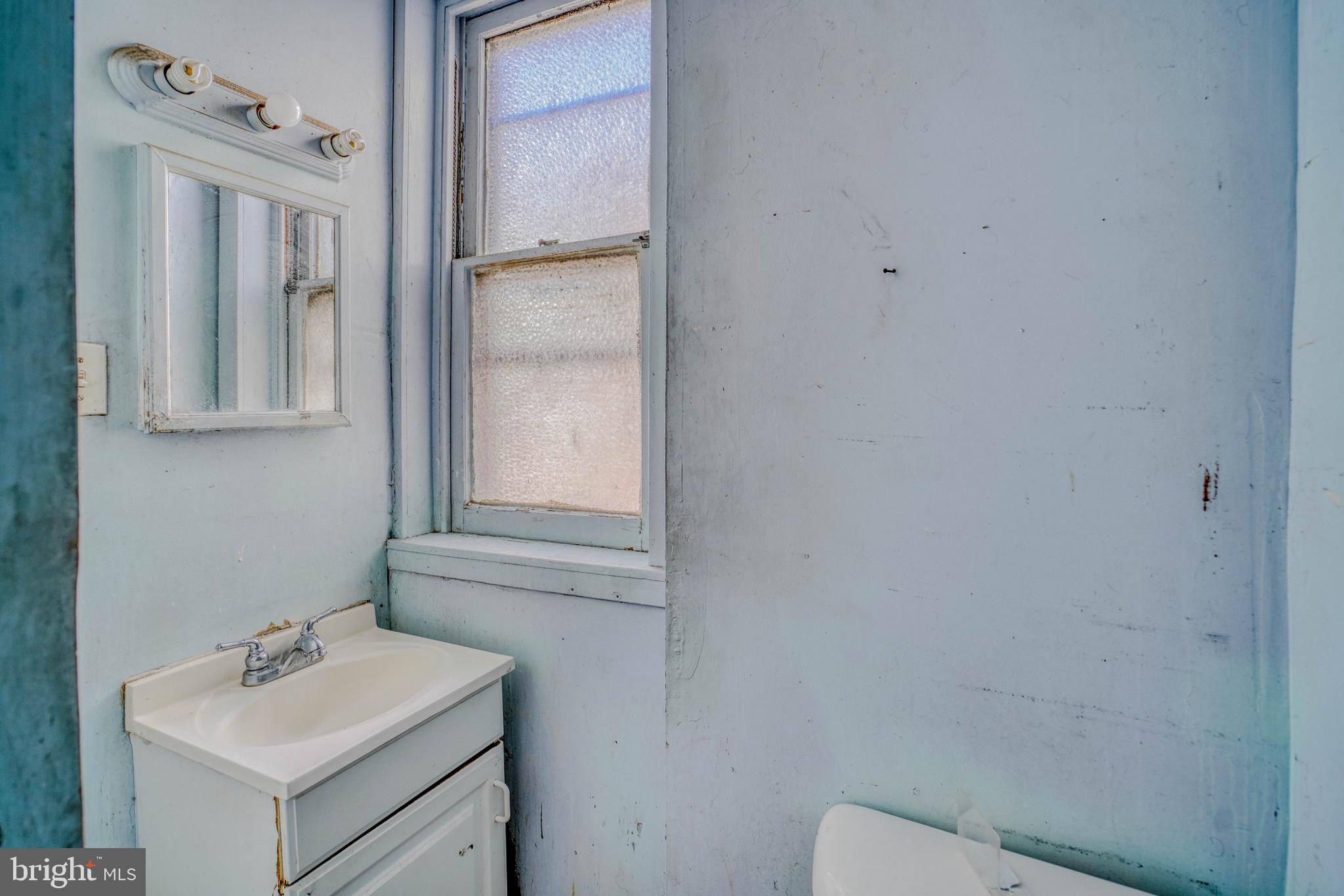 5705 Leonard Street Philadelphia, PA 19149 - Photo 23 of 30 a bathroom with a sink toilet and mirror