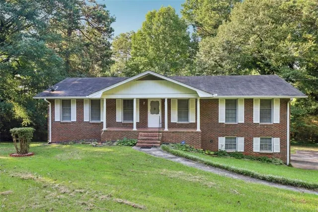 a front view of a house with a garden