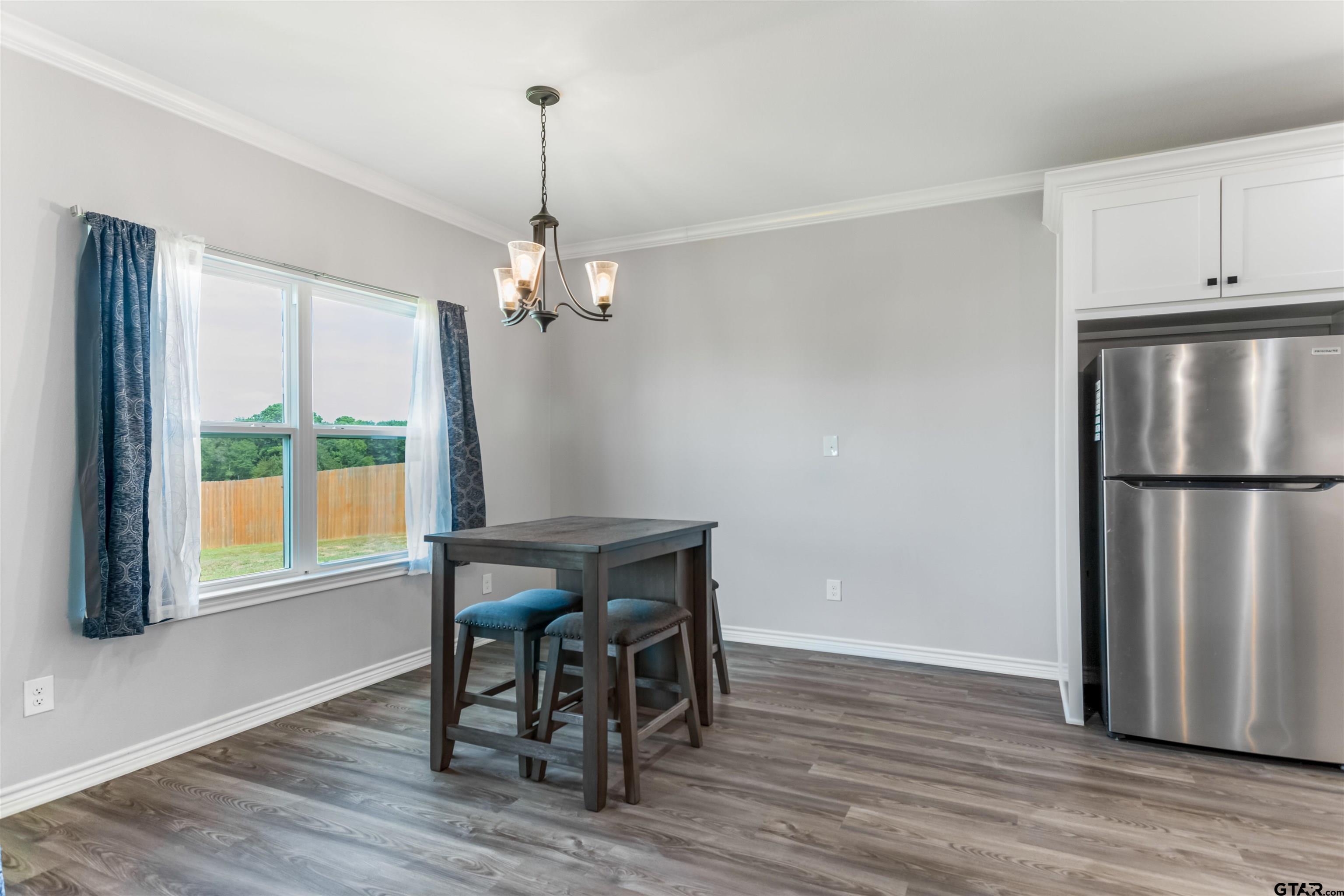 12908 County Road 46 Tyler, TX 75704 - Photo 12 of 24 a view of a dining room with furniture window and wooden floor