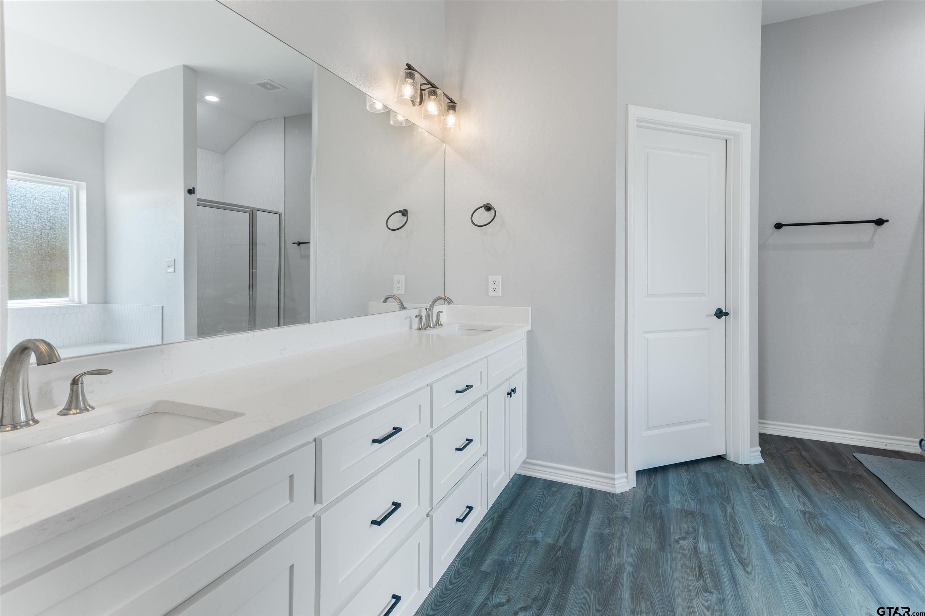 12908 County Road 46 Tyler, TX 75704 - Photo 18 of 24 a bathroom with a double vanity sink and mirror