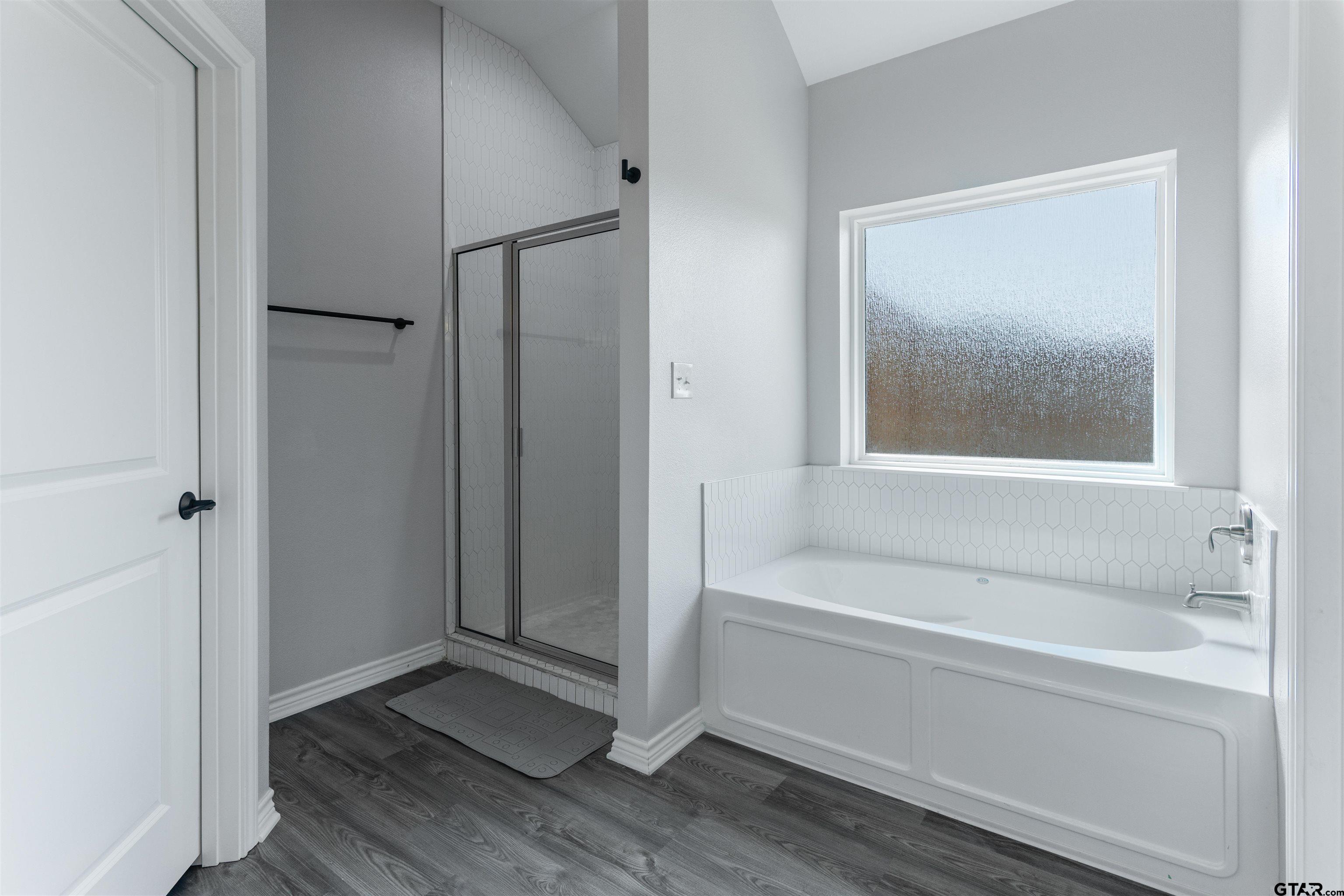 12908 County Road 46 Tyler, TX 75704 - Photo 19 of 24 a bathroom with a bathtub and a shower