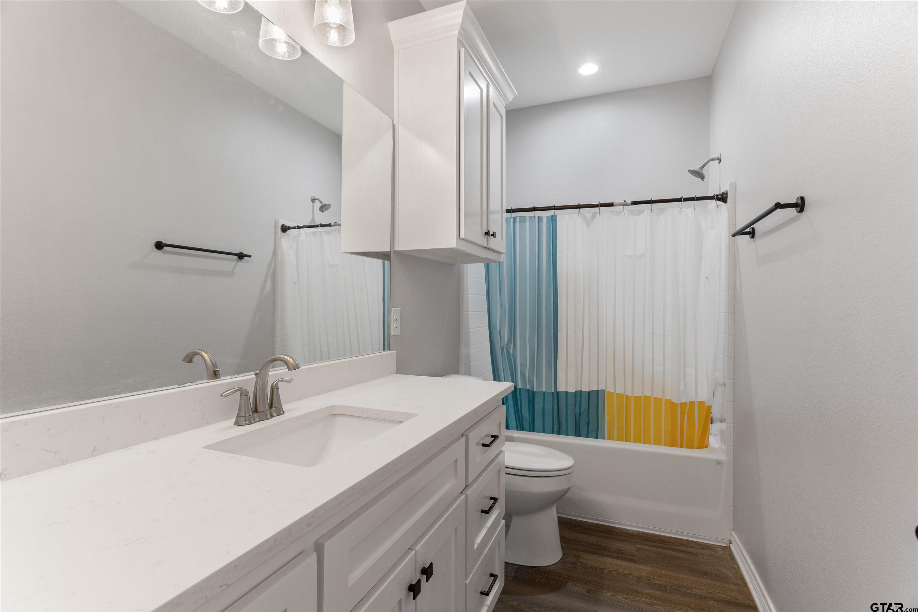 12908 County Road 46 Tyler, TX 75704 - Photo 22 of 24 a bathroom with a sink a toilet and shower