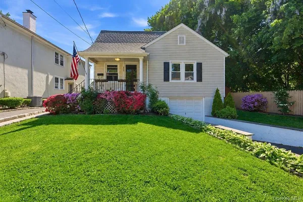 a front view of a house with a garden