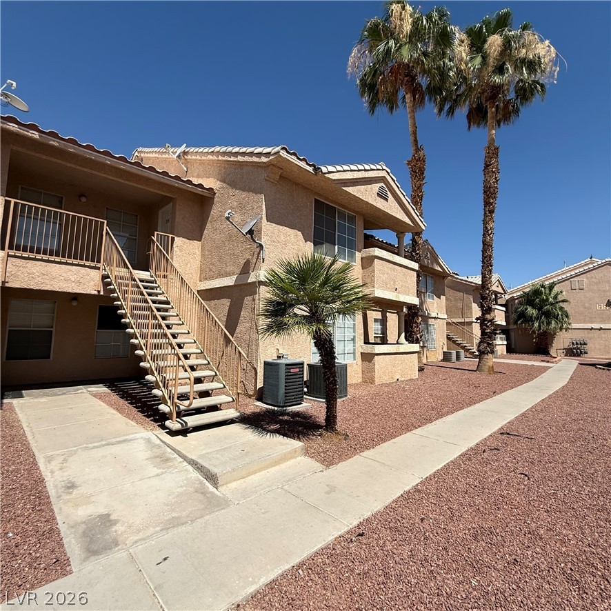 1830 North Pecos Road, Unit 258 Las Vegas, NV 89115 - Photo 2 of 14 Walkways connect these multi-level residences, flanked by drought-resistant landscaping and tropical palms.