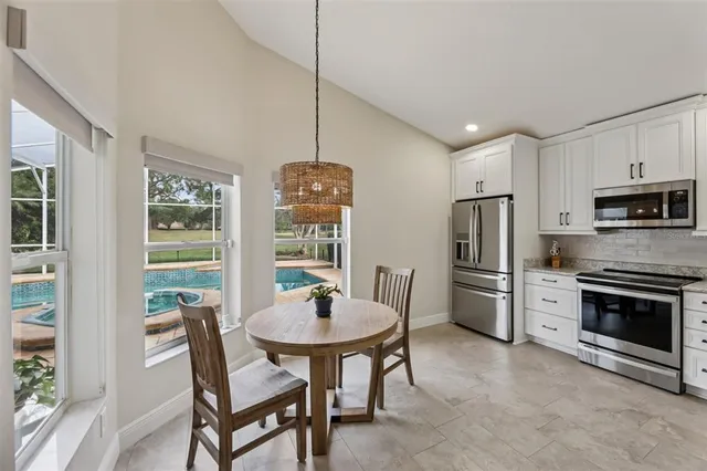 a spacious bathroom with a granite countertop double vanity sink a mirror and a shower
