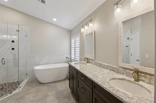 a view of a white building with swimming pool in front of it