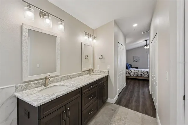 a front view of a house with a garden and trees