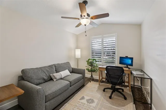 a view of a park that has a sign board large trees