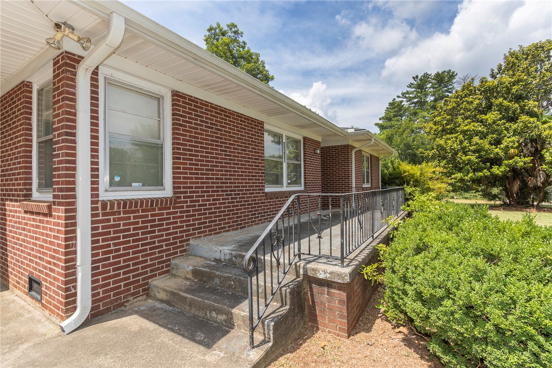 1218 Bolt Drive Anderson, SC 29621 - Photo 4 of 46 A classic brick exterior offers enduring appeal with a welcoming porch and mature landscaping.