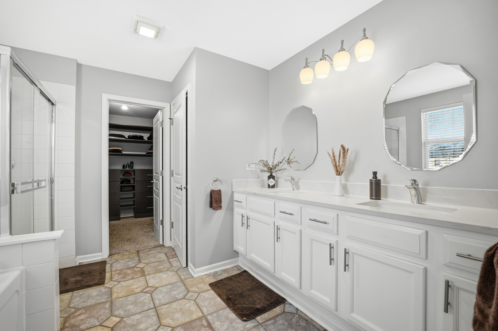 136 Lilac Street Bolingbrook, IL 60490 - Photo 14 of 30 a spacious bathroom with a double vanity sink and a mirror