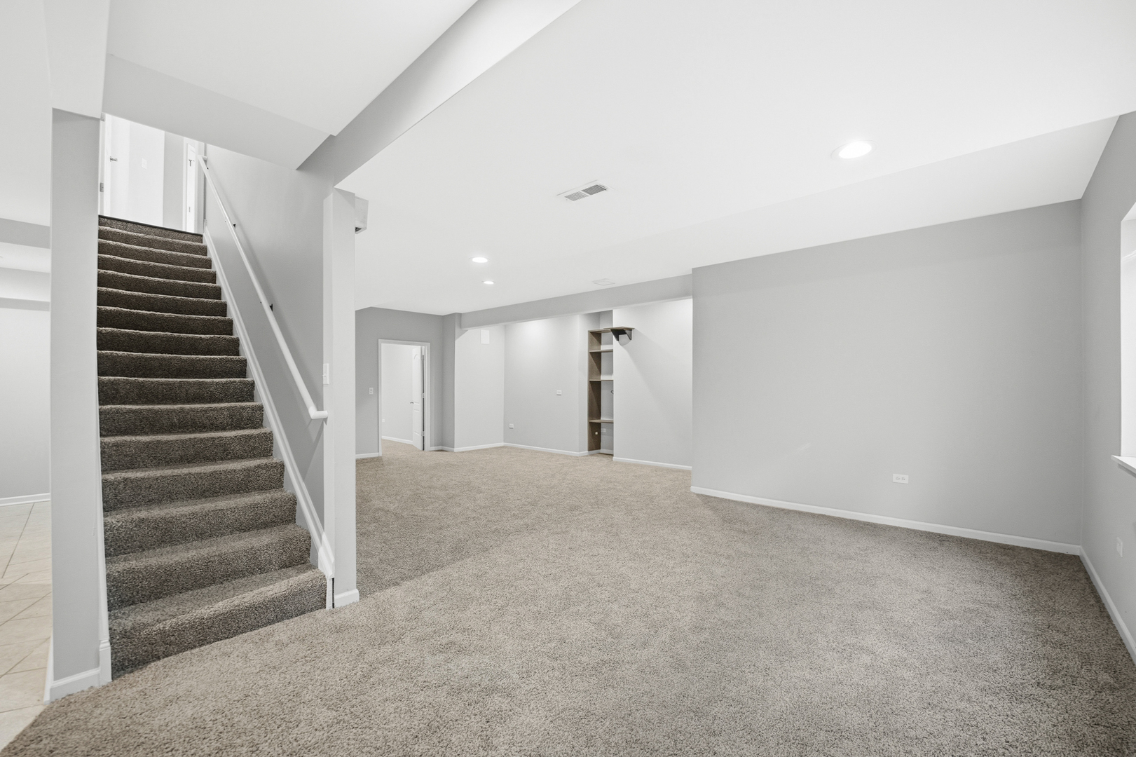 136 Lilac Street Bolingbrook, IL 60490 - Photo 22 of 30 a view of an empty room with stairs