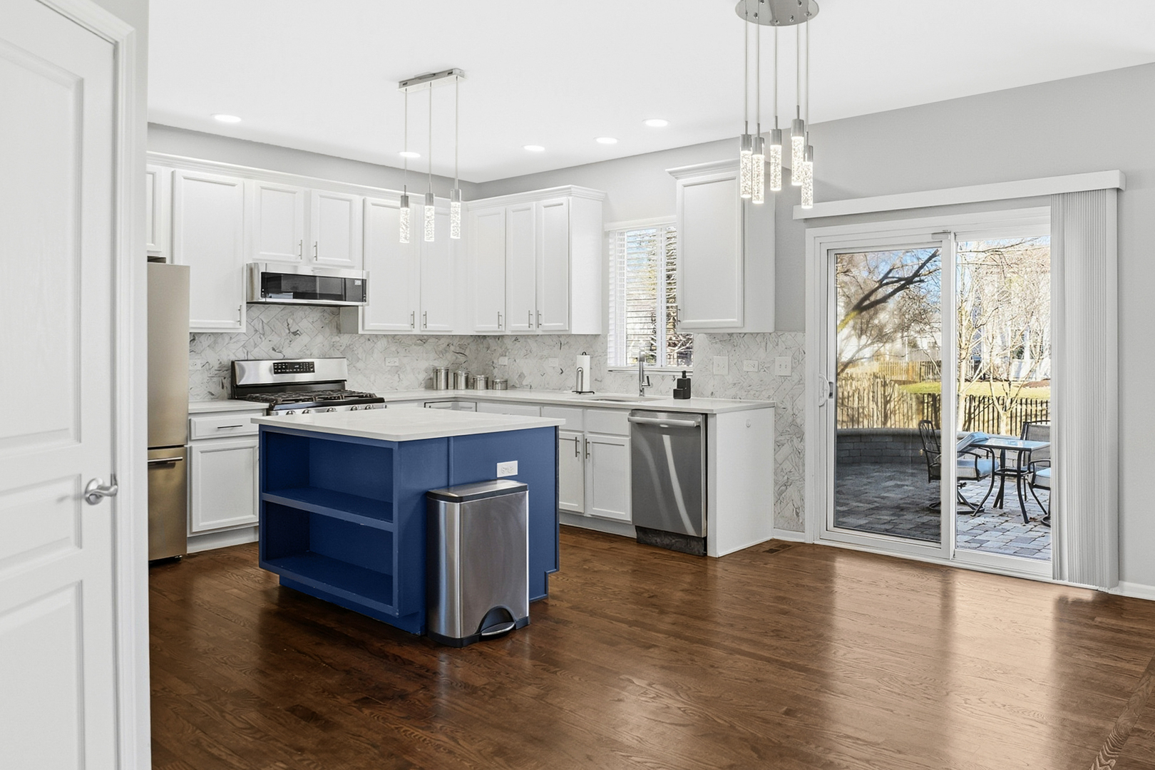 136 Lilac Street Bolingbrook, IL 60490 - Photo 3 of 30 a kitchen with stainless steel appliances granite countertop a stove a sink dishwasher and a refrigerator with wooden floor