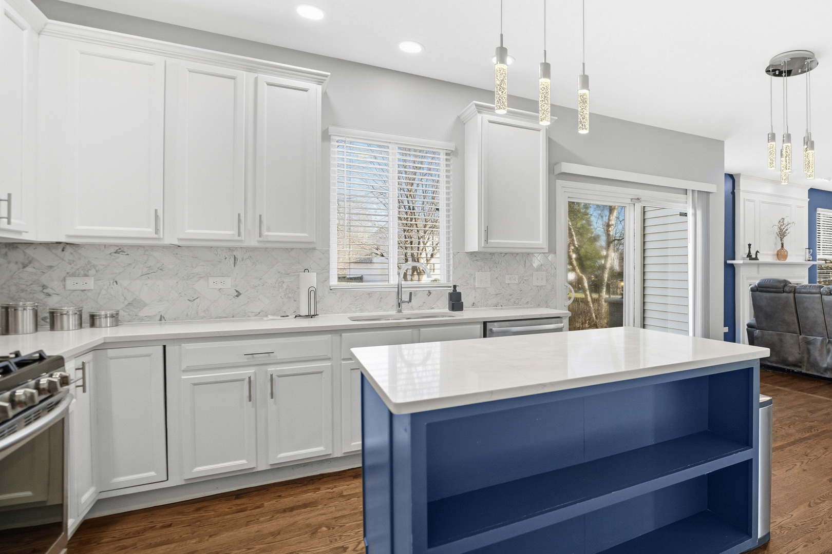 136 Lilac Street Bolingbrook, IL 60490 - Photo 4 of 30 a kitchen with kitchen island granite countertop a sink cabinets and wooden floor
