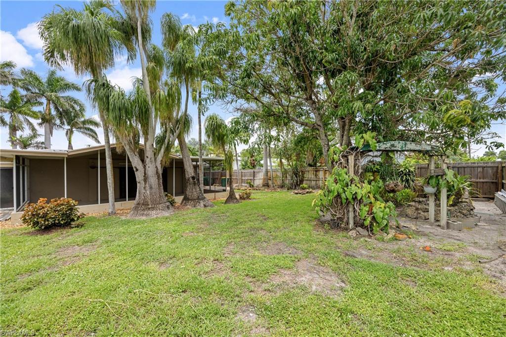 1120 Ridge Street Naples, FL 34103 - Photo 37 of 39 Fenced backyard with a sunroom