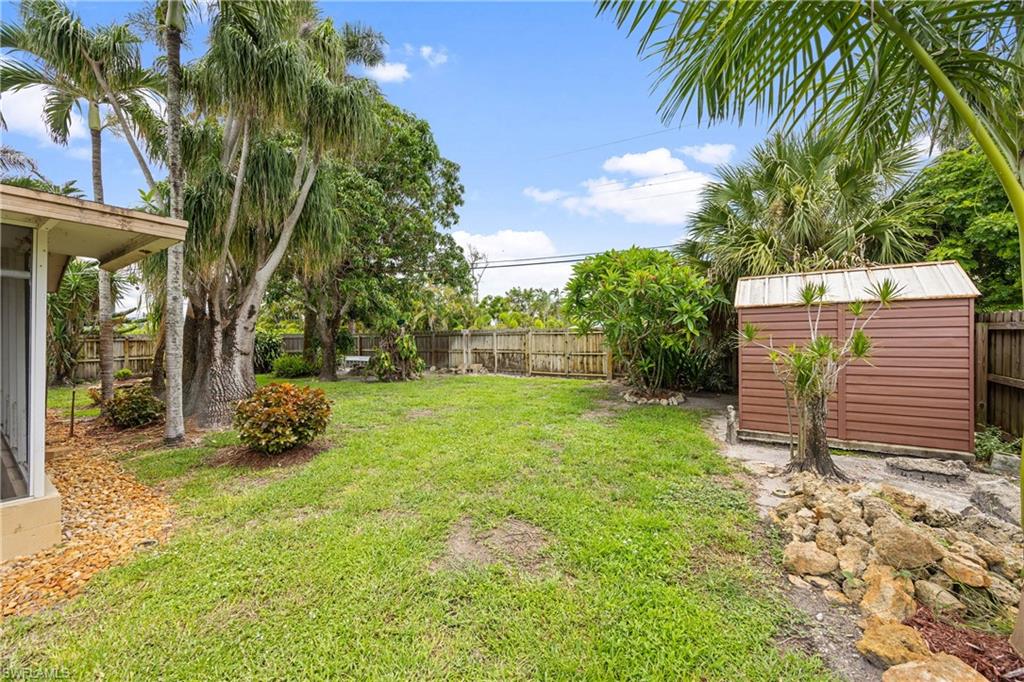 1120 Ridge Street Naples, FL 34103 - Photo 38 of 39 Fenced backyard featuring a storage shed for garden tools or extra storage. *Dont forget this home ALSO has an OVERSIZE 2 CAR GARAGE!*