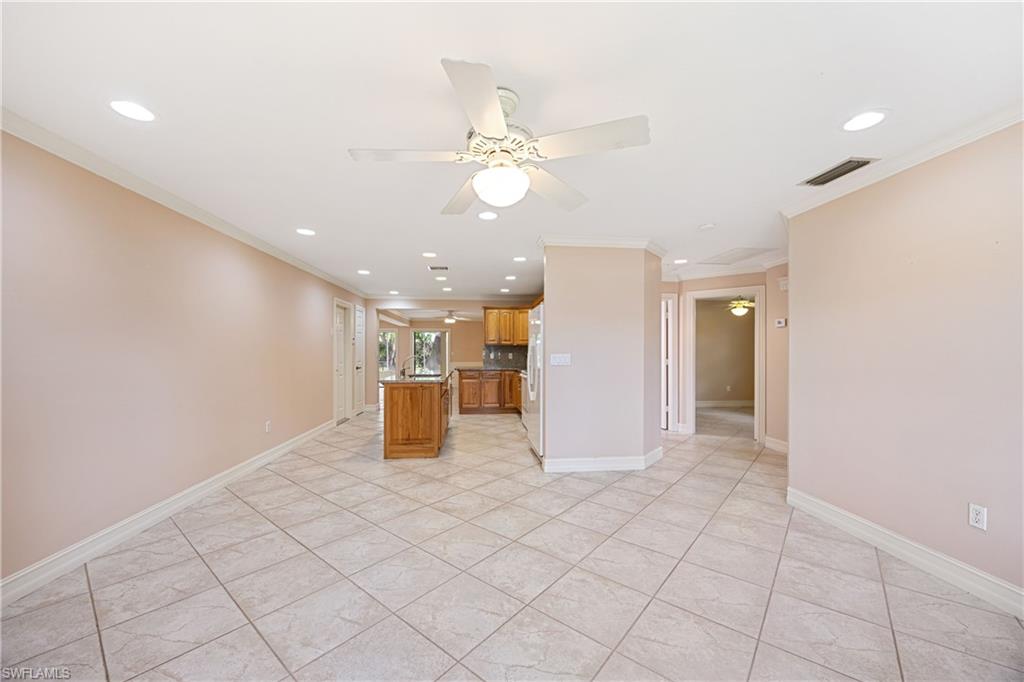 1120 Ridge Street Naples, FL 34103 - Photo 5 of 39 Kitchen featuring ornamental molding, ceiling fan, recessed lighting, a kitchen island, and brown cabinets