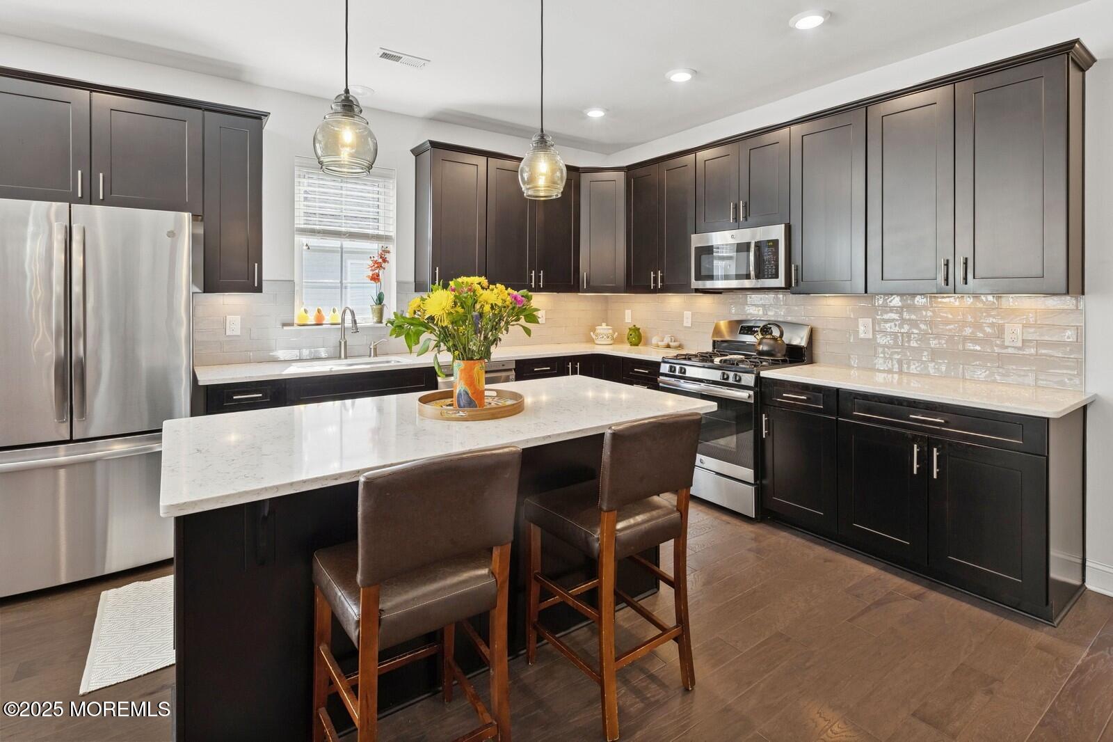 60 Butler Drive Barnegat, NJ 08005 - Photo 11 of 59 a kitchen with a refrigerator a stove a sink a dining table and chairs